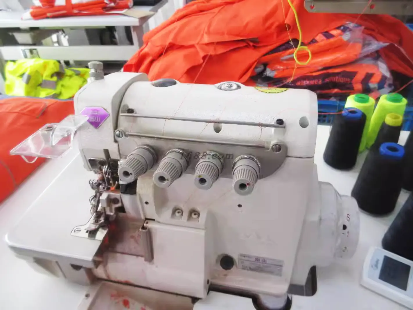 Overlock sewing machine and garment panels during workwear production